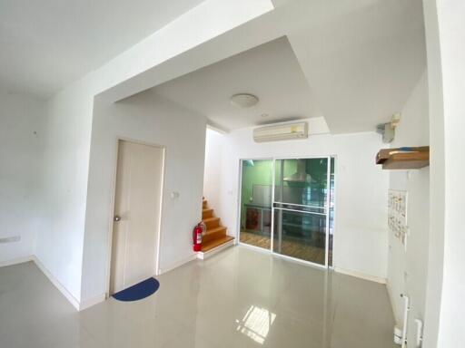 Modern living area with stairwell and glass doors