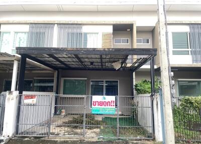 Front view of the property with covered parking area