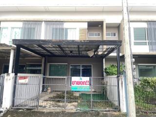 Front view of the property with covered parking area