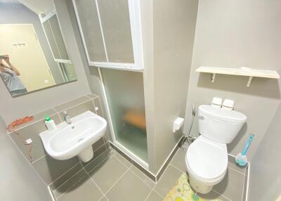 Modern bathroom with sink, toilet, and shower area