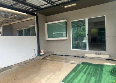 Covered parking area with sliding glass door entrance