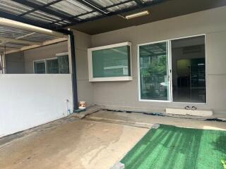 Covered parking area with sliding glass door entrance