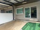 Covered parking area with sliding glass door entrance