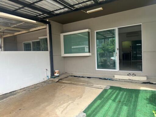 Covered parking area with sliding glass door entrance