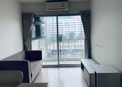 Living room with sliding glass door and city view