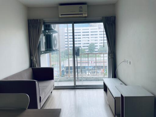 Living room with sliding glass door and city view