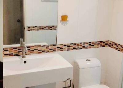 Modern bathroom with white fixtures and large mirror