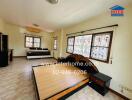 Spacious bedroom with bed frame, sofa, and windows