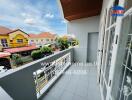 Spacious balcony with railing and view of surrounding neighborhood