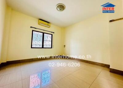 Empty bedroom with tiled floor and window