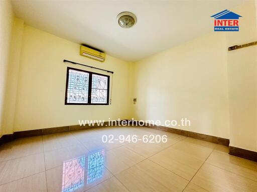 Empty bedroom with tiled floor and window