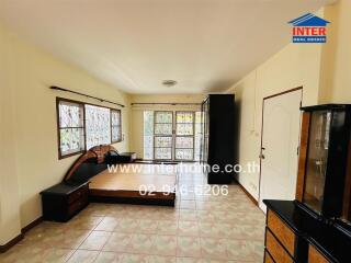 Spacious, well-lit living room with furniture