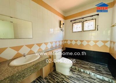 Bathroom with modern fixtures and decorative tiles