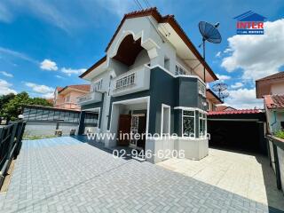 Modern two-story house with driveway and a covered carport