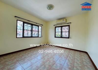 Photo of a living room with windows, tiled floor, and air conditioning unit