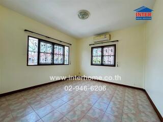 Photo of a living room with windows, tiled floor, and air conditioning unit