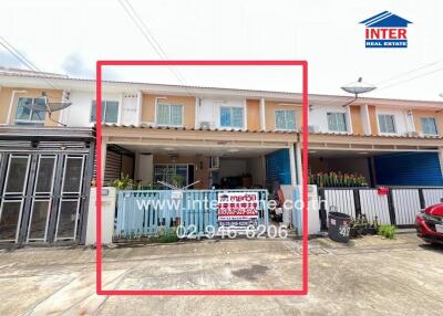 Front view of a townhouse with garage and fence