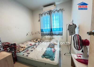 Small bedroom with bed and air conditioner