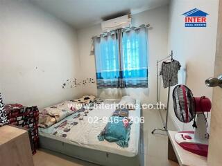 Small bedroom with bed and air conditioner