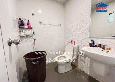 Modern bathroom with white tiles and essential fixtures