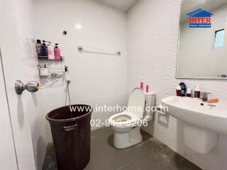 Modern bathroom with white tiles and essential fixtures