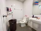 Modern bathroom with white tiles and essential fixtures