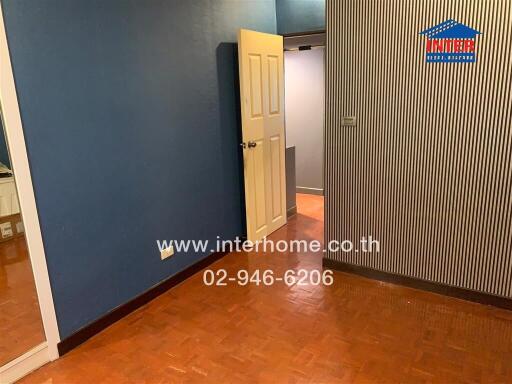 Bedroom with blue walls and wooden floor