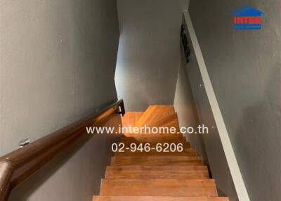 Staircase with wooden steps and handrail