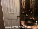 Small bathroom with mirror, sink, and tiled walls