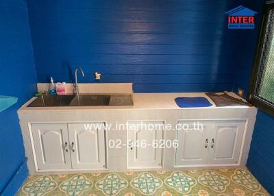 Small kitchen with blue walls and a sink