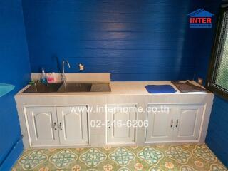 Small kitchen with blue walls and a sink