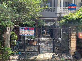 Front view of a house entrance with a gate