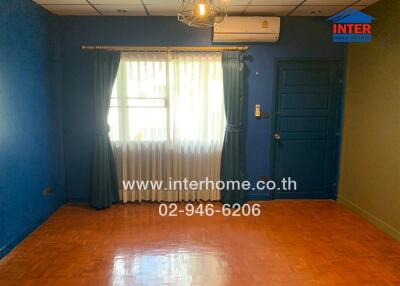 Living space with blue walls and curtains