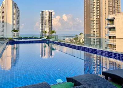 Rooftop pool area with scenic city view