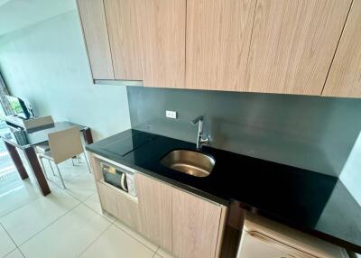 Modern kitchen with sink, stovetop, and dining area