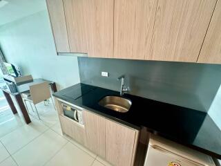 Modern kitchen with sink, stovetop, and dining area