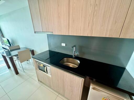 Modern kitchen with sink, stovetop, and dining area