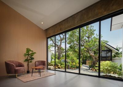 Modern living room with large glass windows and garden view