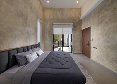 Modern bedroom with a large bed and a view of an outdoor space