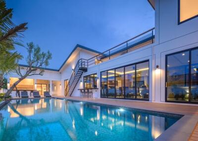 Modern luxury house with pool at dusk