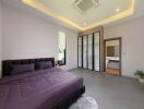 Spacious modern bedroom with a bed, wardrobe, and en suite bathroom