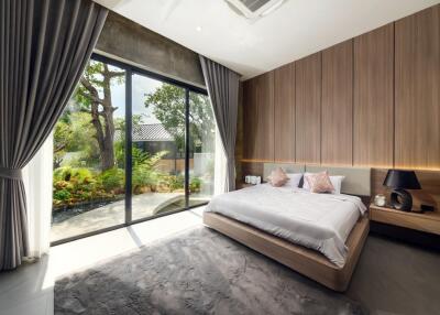 Spacious bedroom with large glass doors and garden view