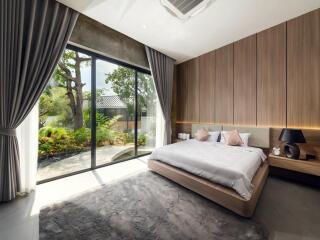 Spacious bedroom with large glass doors and garden view