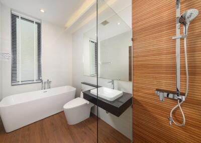 Modern bathroom with bathtub, shower, and vanity