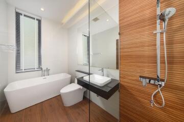 Modern bathroom with bathtub, shower, and vanity