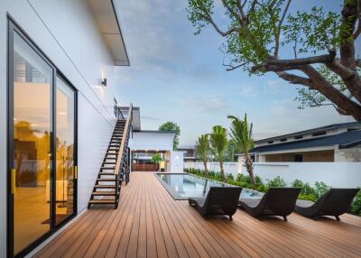 Modern backyard with pool and lounge chairs