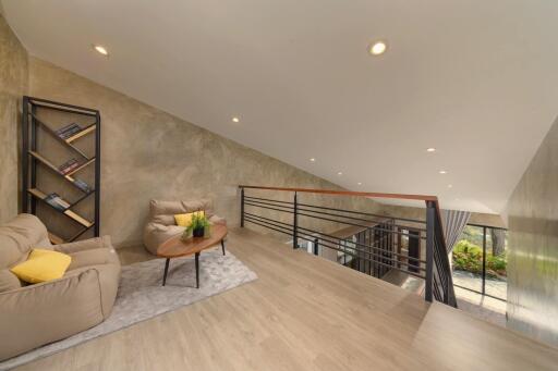 Modern loft living area with comfortable seating and bookshelf