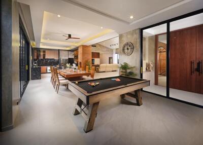 Spacious and modern living area with dining table and pool table