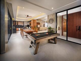 Spacious and modern living area with dining table and pool table