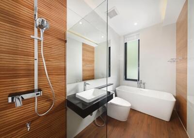 Modern bathroom with wooden elements and glass partition